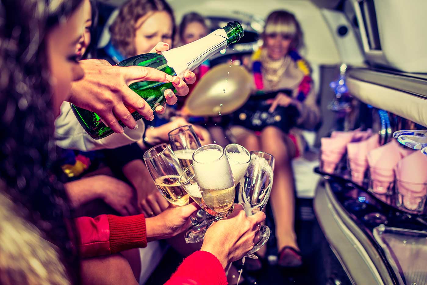 The image shows a group of women celebrating in a limousine, likely for a bachelorette party